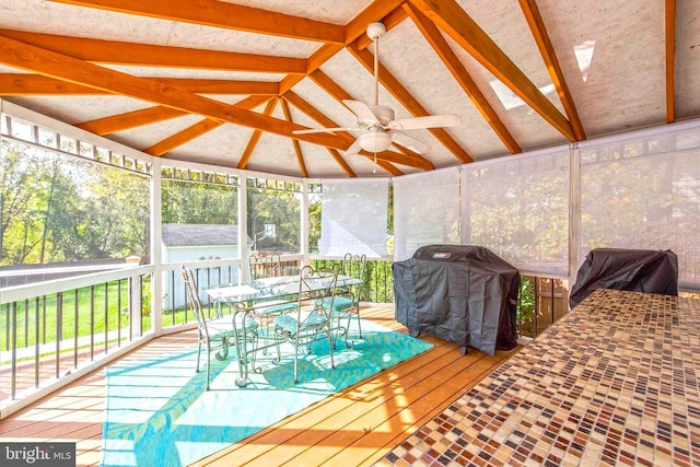 sunroom with vaulted ceiling and ceiling fan