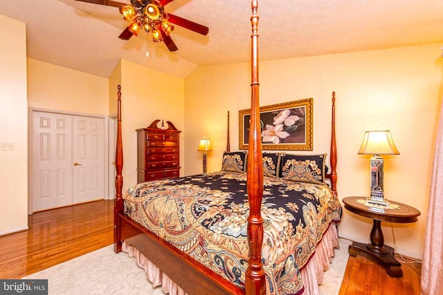 bedroom with lofted ceiling, ceiling fan, and wood finished floors