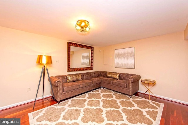 living area featuring baseboards and wood finished floors