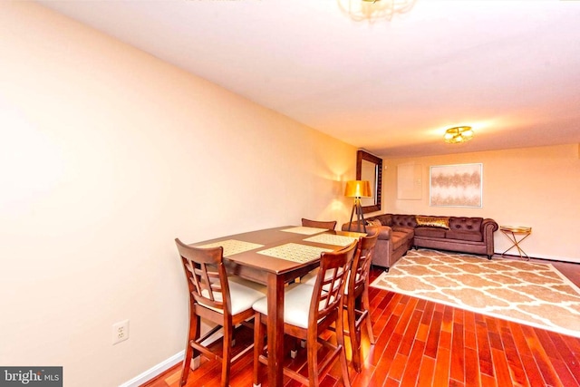 dining area featuring baseboards and wood finished floors