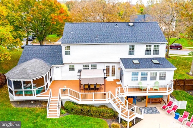 rear view of house featuring stairs, a shingled roof, and a wooden deck