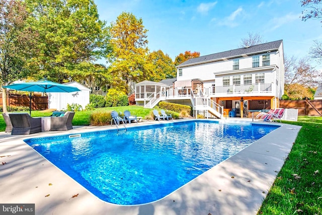 view of swimming pool with a deck, a fenced backyard, stairs, a fenced in pool, and a patio area