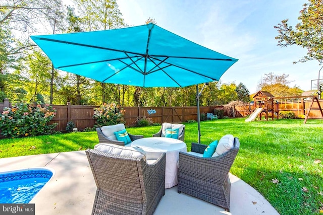 view of patio / terrace featuring outdoor dining area, a fenced backyard, and a playground