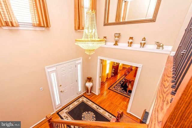 entryway featuring an inviting chandelier, visible vents, and wood finished floors