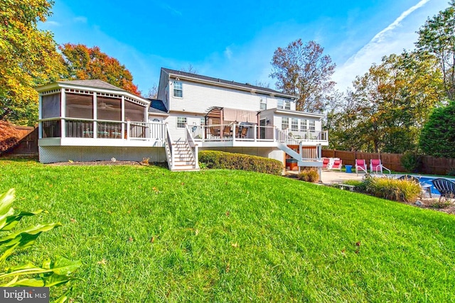 rear view of property with a patio, a fenced backyard, a sunroom, stairs, and a wooden deck