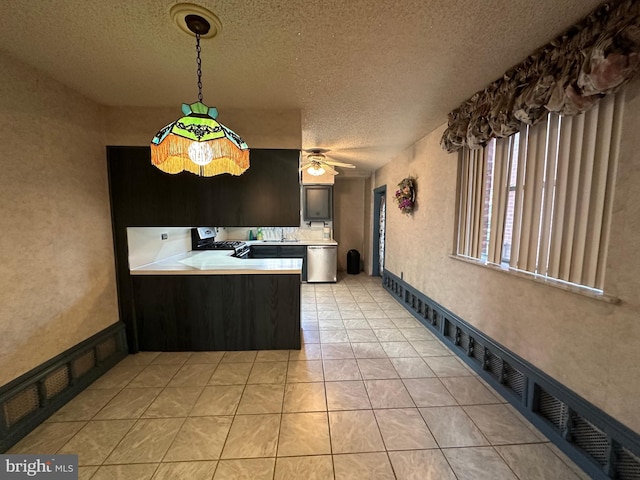 kitchen with a textured ceiling, light tile patterned floors, kitchen peninsula, dishwasher, and ceiling fan