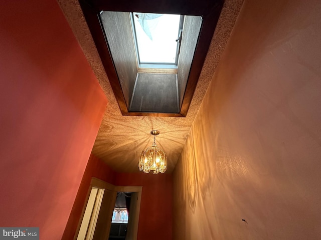 interior details featuring an inviting chandelier