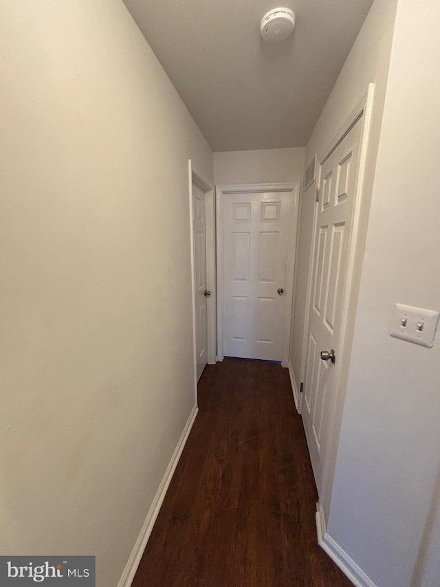 hallway with dark wood-type flooring