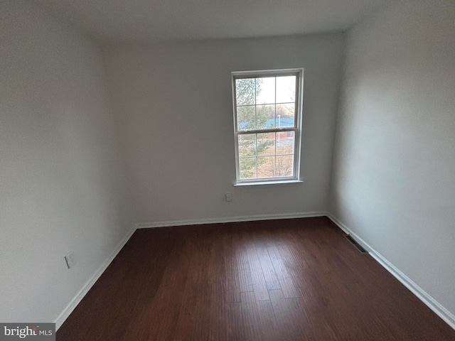 empty room with dark hardwood / wood-style floors