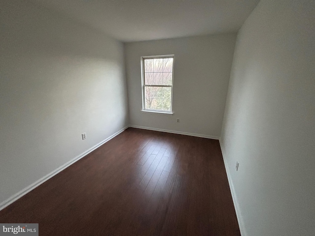 empty room with dark wood-type flooring