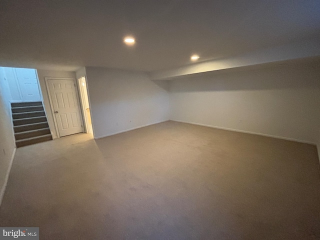 basement featuring light carpet