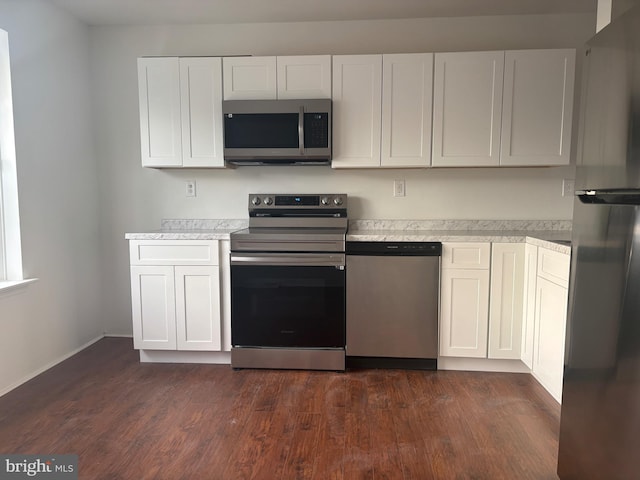 kitchen featuring white cabinetry, dark hardwood / wood-style flooring, and stainless steel appliances