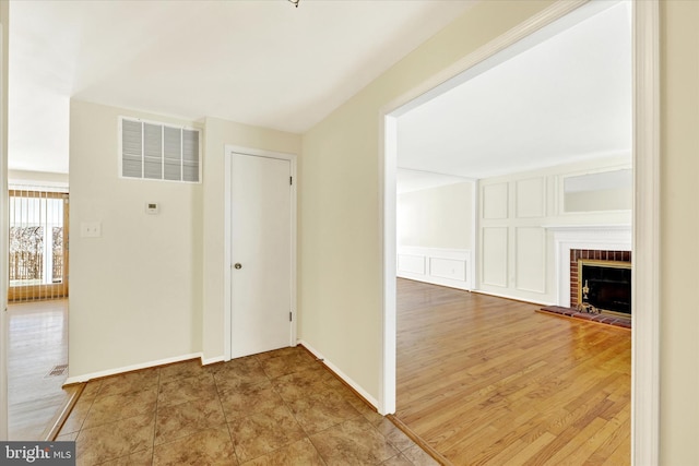 corridor with hardwood / wood-style floors