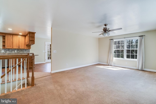 unfurnished living room with recessed lighting, baseboards, light colored carpet, and a ceiling fan