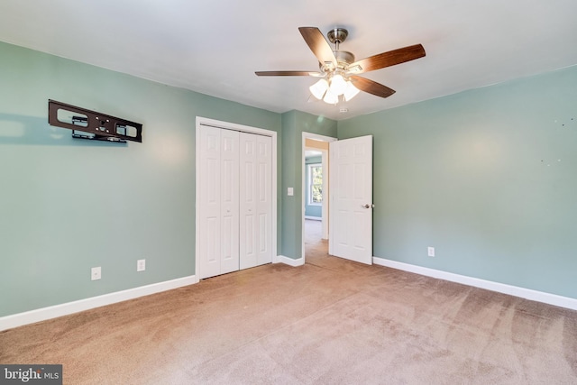 unfurnished bedroom with a closet, ceiling fan, baseboards, and carpet