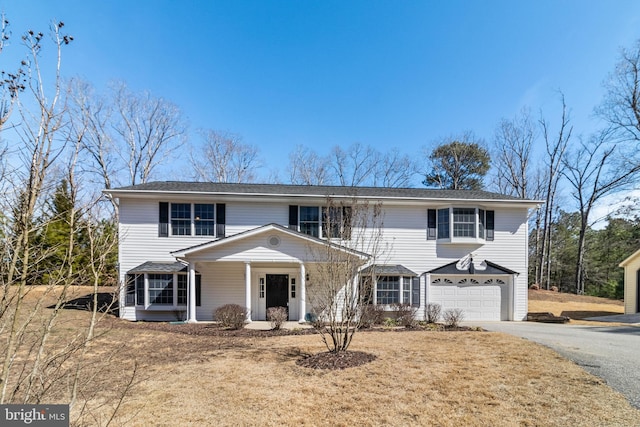 view of front of house with aphalt driveway and a garage