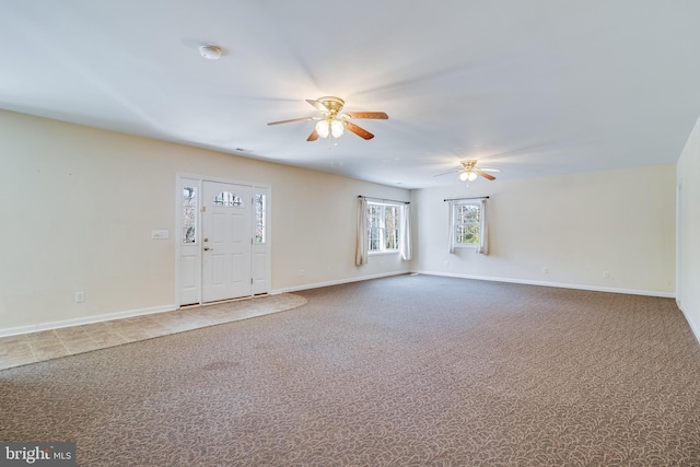 unfurnished living room featuring baseboards, carpet floors, and ceiling fan