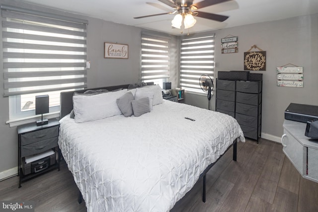 bedroom with dark hardwood / wood-style flooring and ceiling fan