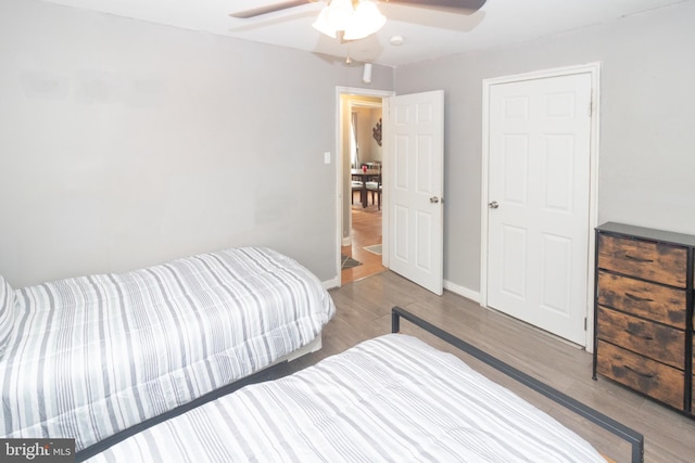 bedroom with ceiling fan and hardwood / wood-style floors