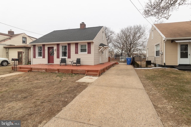 view of front of property with a wooden deck, a front yard, and central AC unit