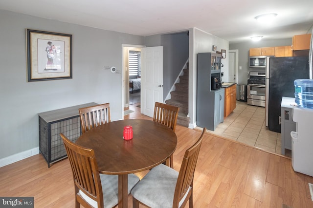 dining space with light wood-type flooring