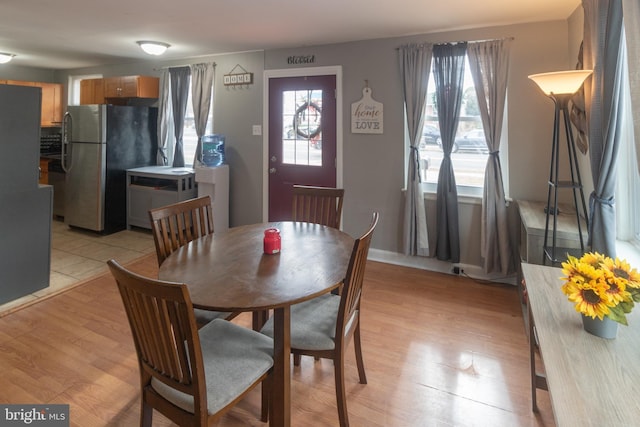 dining area featuring a healthy amount of sunlight and light hardwood / wood-style floors