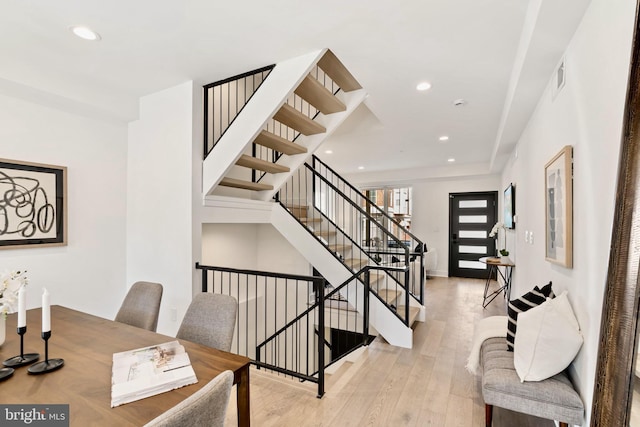 stairway featuring wood-type flooring