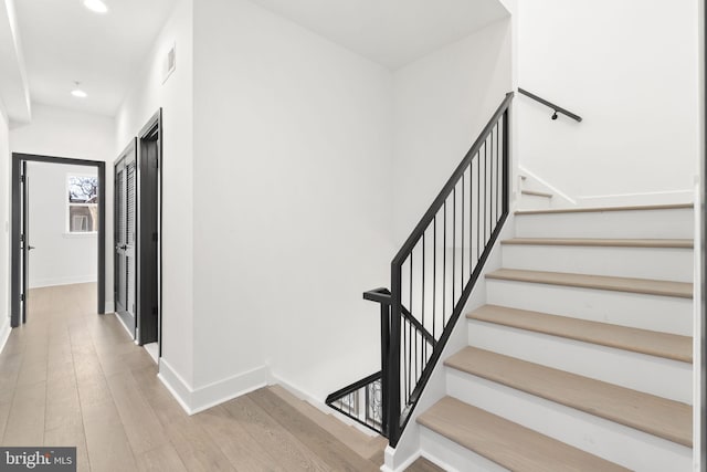 stairs featuring hardwood / wood-style flooring