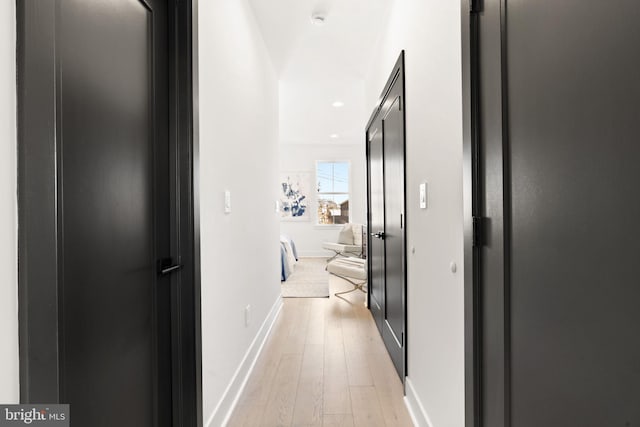 corridor with light hardwood / wood-style floors