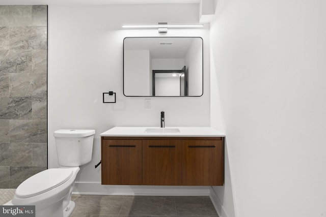 bathroom with vanity, walk in shower, and toilet