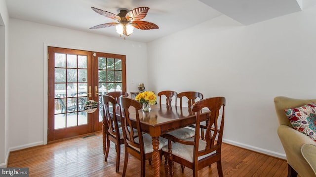 dining room featuring hardwood / wood-style floors, ceiling fan, and french doors