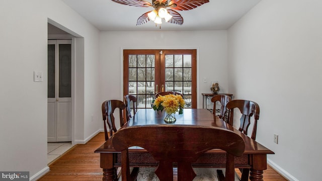 dining room featuring light hardwood / wood-style flooring, ceiling fan, and french doors