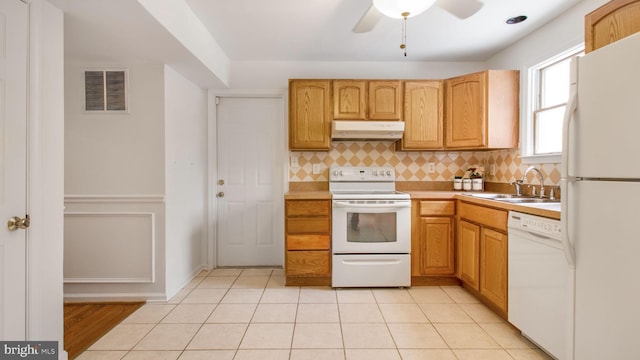 kitchen featuring sink, light tile patterned floors, white appliances, and decorative backsplash