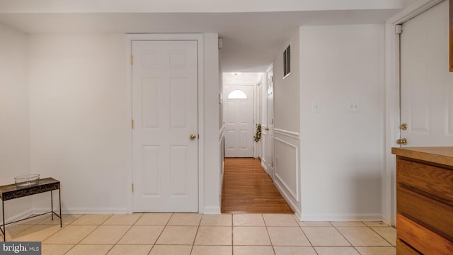 hall with light tile patterned floors