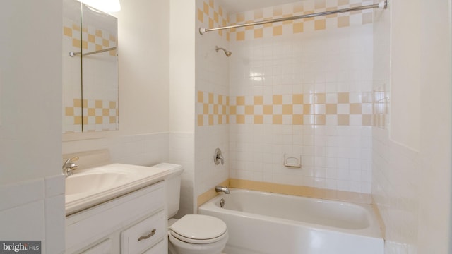 full bathroom with vanity, toilet, and tiled shower / bath combo