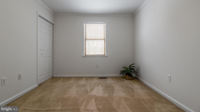 unfurnished bedroom featuring crown molding and light colored carpet