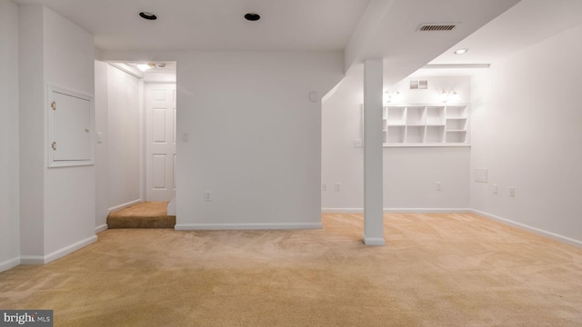 basement featuring light carpet