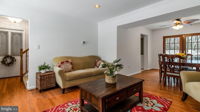 living room featuring ornamental molding, ceiling fan, and light hardwood / wood-style floors