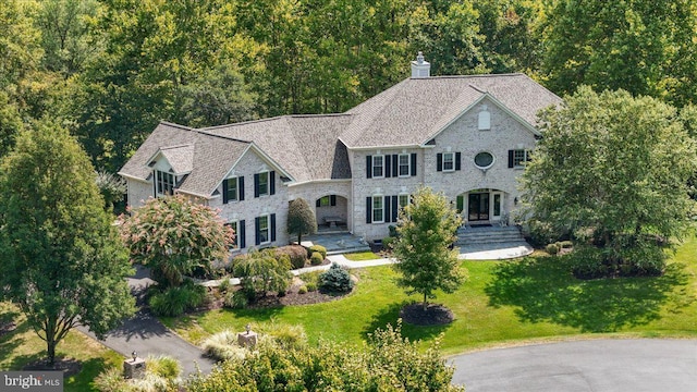 view of front of property with a chimney and a front yard