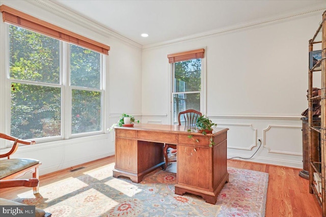 office featuring a wainscoted wall, light wood finished floors, recessed lighting, crown molding, and a decorative wall