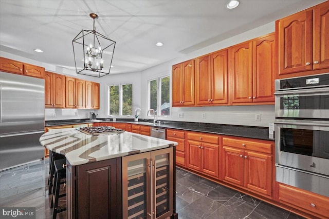 kitchen featuring a warming drawer, dark stone countertops, decorative light fixtures, appliances with stainless steel finishes, and brown cabinetry