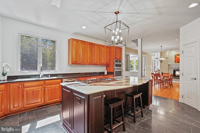 kitchen featuring a chandelier, hanging light fixtures, a center island, and stainless steel appliances