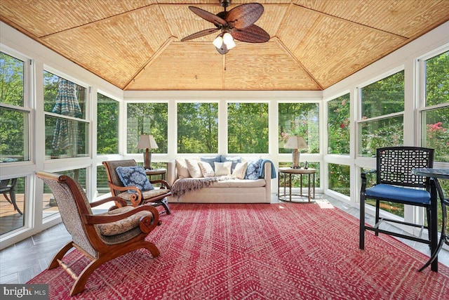 sunroom / solarium featuring lofted ceiling, wood ceiling, and ceiling fan