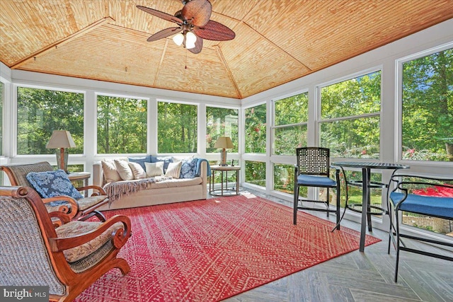 sunroom / solarium with wooden ceiling, ceiling fan, and vaulted ceiling