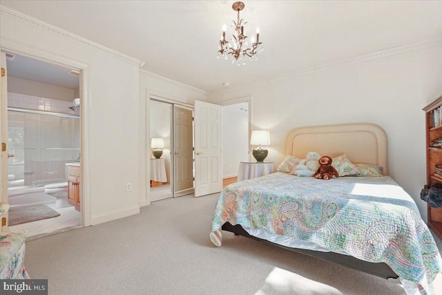 carpeted bedroom with ornamental molding, ensuite bath, a closet, an inviting chandelier, and baseboards