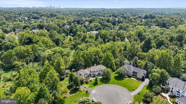 drone / aerial view with a wooded view