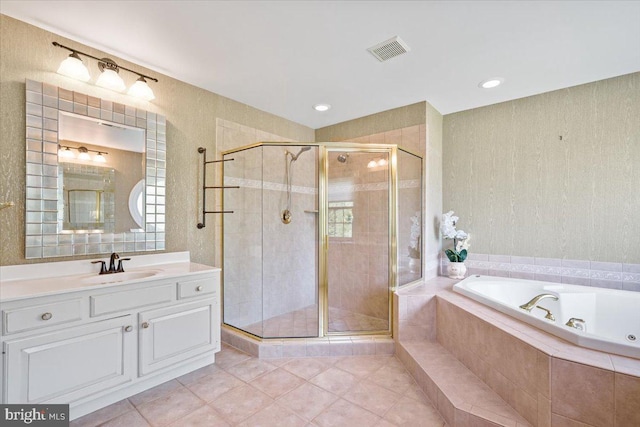 bathroom featuring visible vents, a shower stall, vanity, and a garden tub