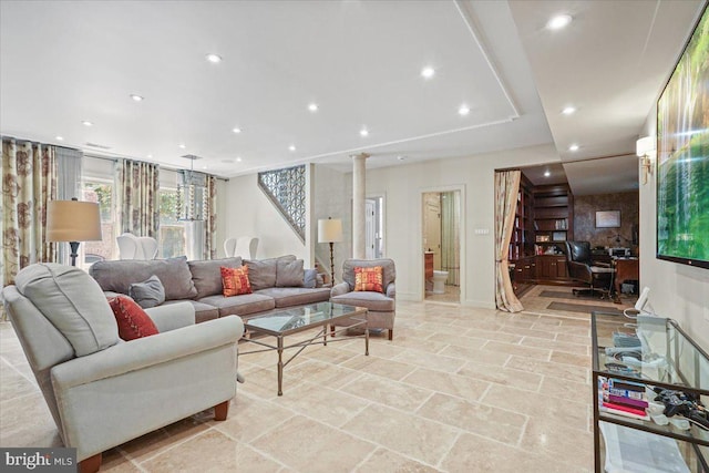 living room featuring recessed lighting, decorative columns, stairs, and stone finish floor