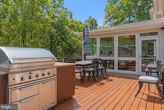 wooden deck featuring outdoor dining area and area for grilling