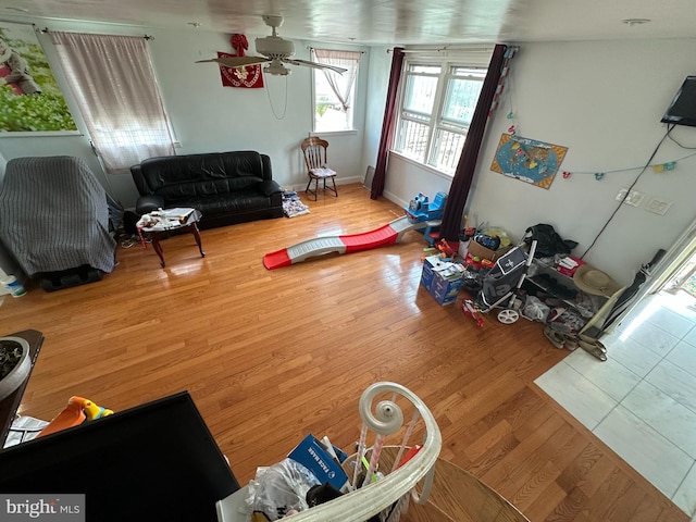 living room featuring ceiling fan and wood-type flooring